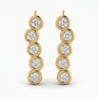 Luxury yellow gold ear crawler earrings with round bezel-set diamonds in angled studio product photo