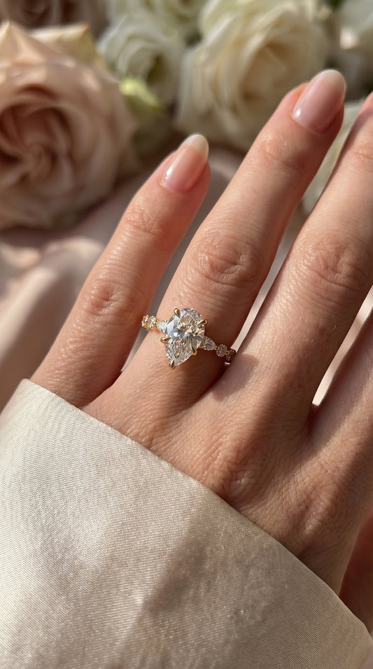 Elegant Pear Cut Diamond Side Stones Engagement Ring