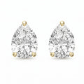 Pair of pear-shaped diamond earrings with gold prongs on a white background
