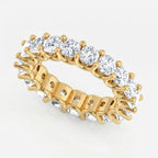 Gold ring with clear gemstones on a white background