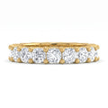 Gold ring with multiple diamonds on a white background