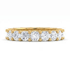 Gold ring with multiple diamonds on a white background