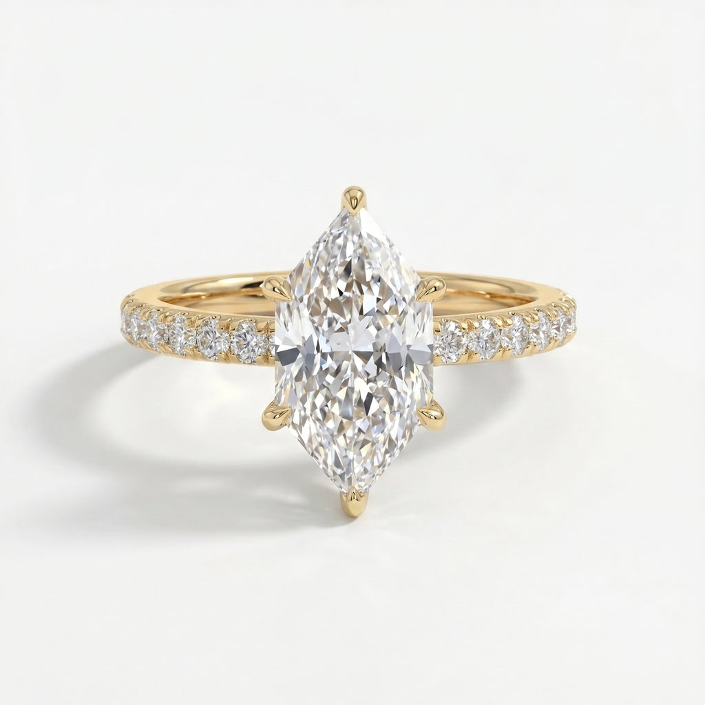 Marquise cut diamond engagement ring in yellow gold with pavé diamond band and six-prong cathedral setting