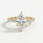 Marquise cut diamond engagement ring in yellow gold with pavé diamond band and six-prong cathedral setting