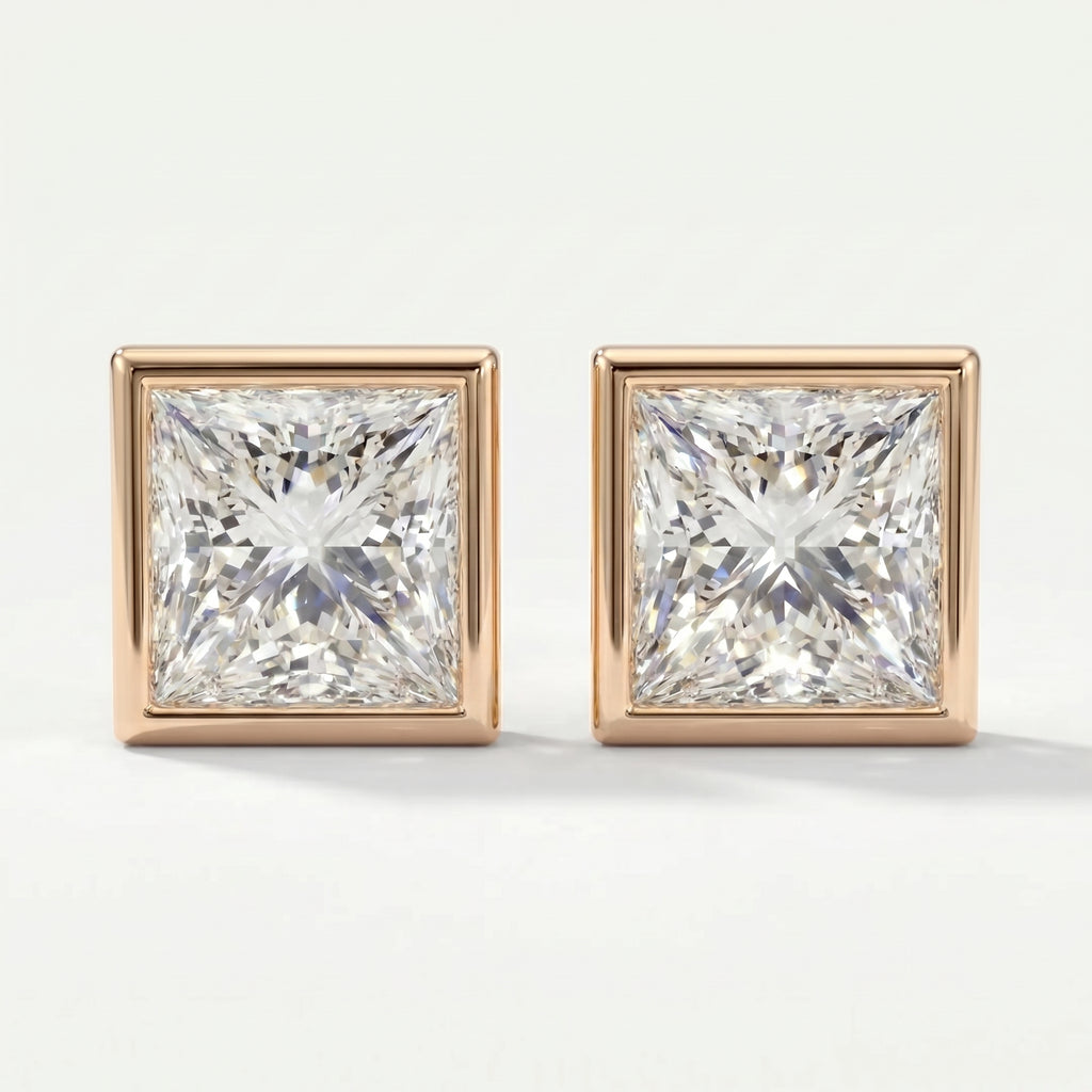 Pair of square-cut diamond earrings with rose gold settings on a white background