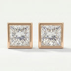 Pair of square-cut diamond earrings with rose gold settings on a white background