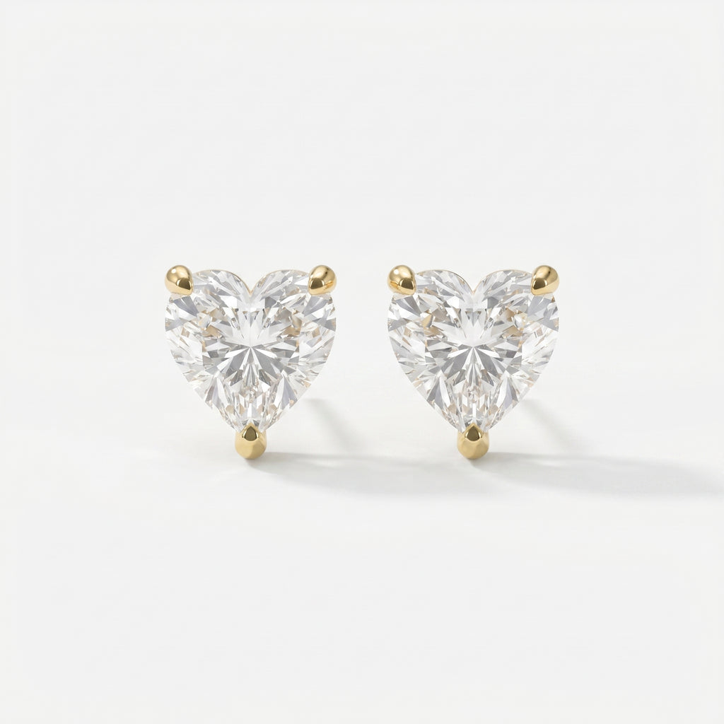 Heart-shaped diamond earrings on a white background