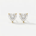 Heart-shaped diamond earrings on a white background