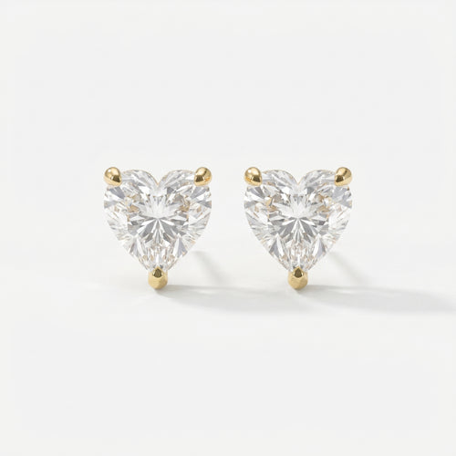 Heart-shaped diamond earrings on a white background
