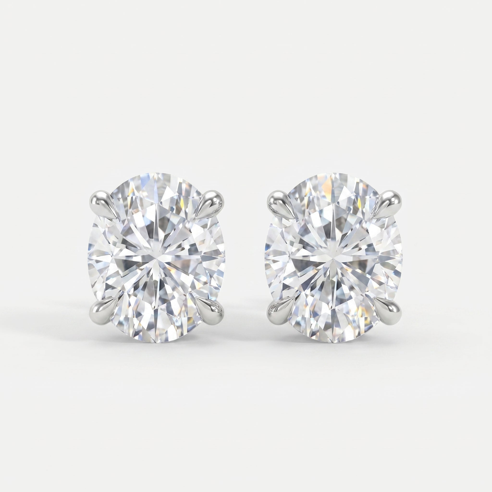 Pair of diamond stud earrings on a light gray background