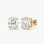 Gold earrings with clear gemstones on a white background