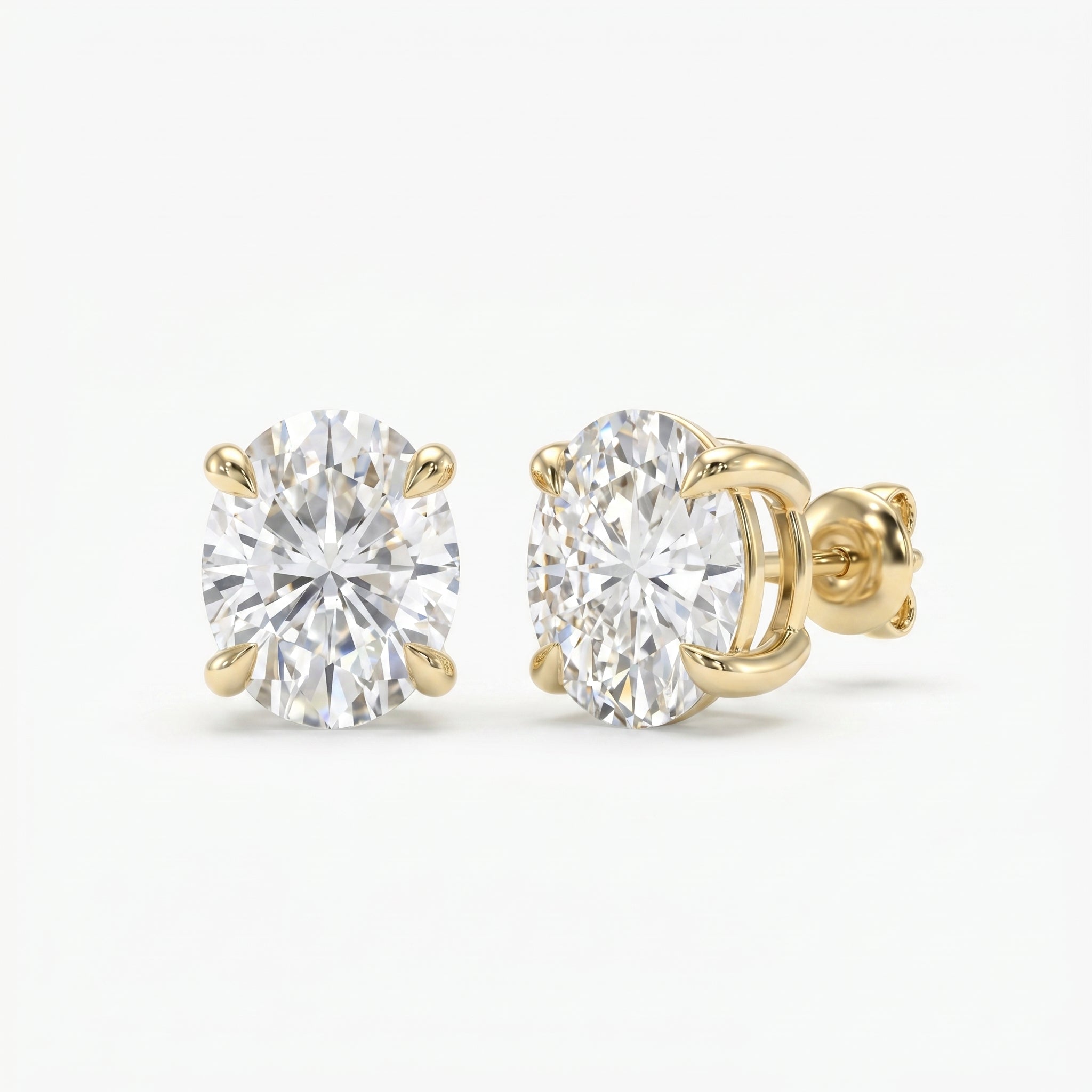 Gold earrings with clear gemstones on a white background