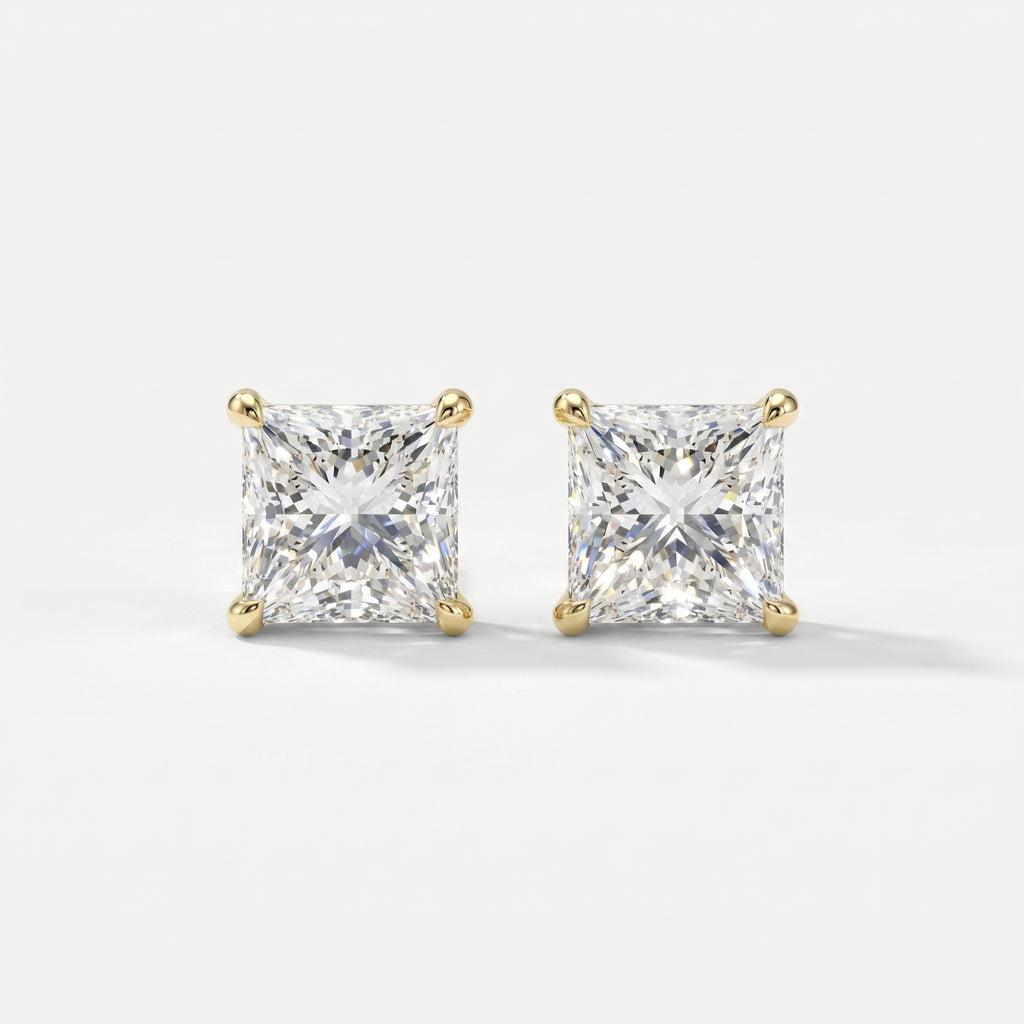 Pair of diamond stud earrings on a light gray background
