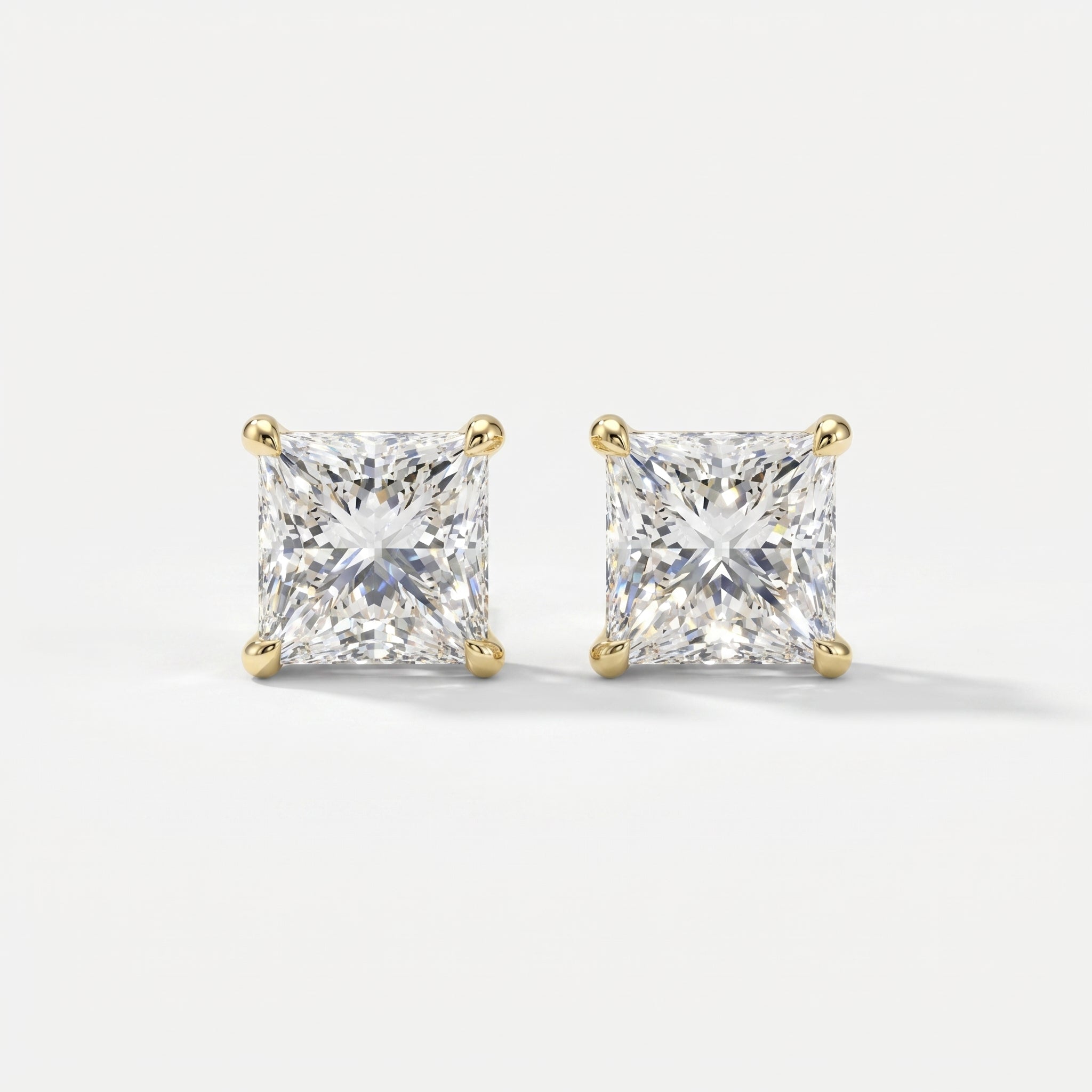 Pair of diamond stud earrings on a light gray background