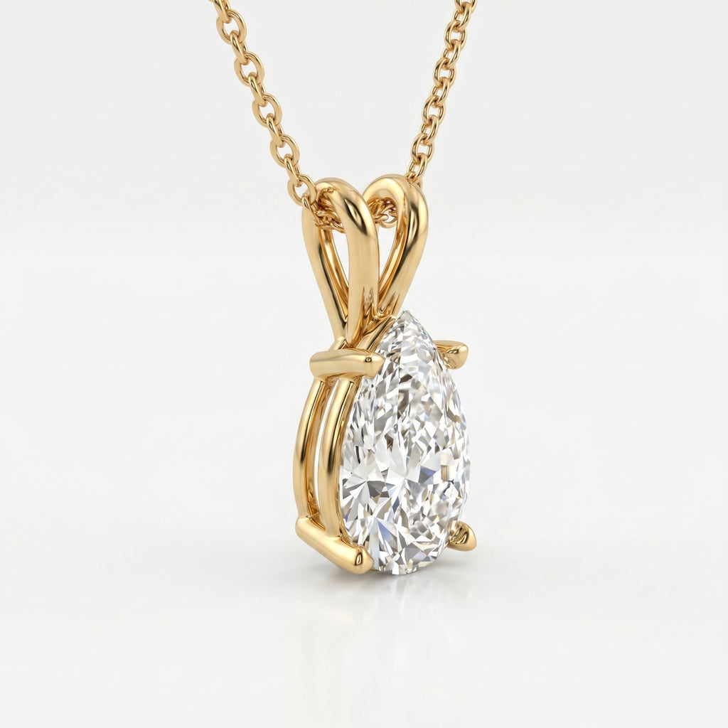 Gold necklace with a pear-shaped diamond pendant on a white background