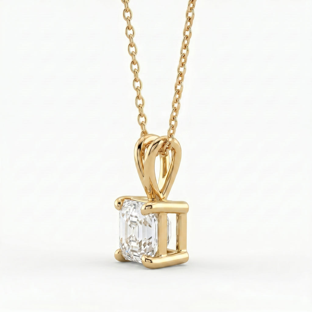 Gold pendant with a diamond on a white background