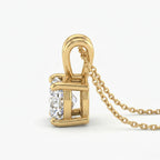 Gold necklace with a diamond pendant on a white background