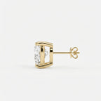 Gold earring with a clear gemstone on a white background