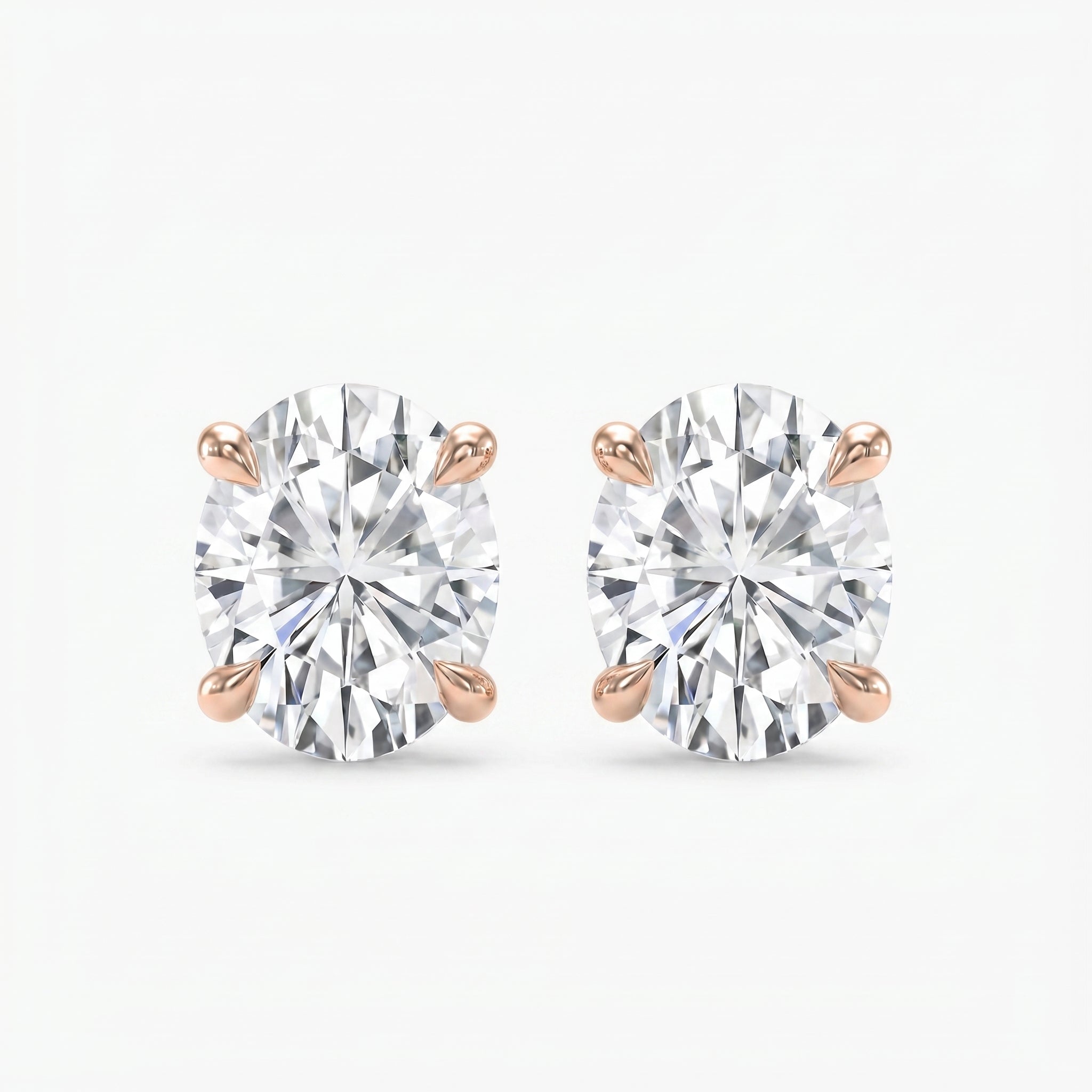 Pair of diamond stud earrings on a white background