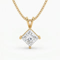 Gold necklace with a diamond pendant on a white background