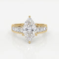 Marquise diamond engagement ring in yellow gold with baguette side stones and cathedral setting on white background