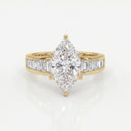 Marquise diamond engagement ring in yellow gold with baguette side stones and cathedral setting on white background