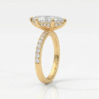 Luxury marquise diamond engagement ring in yellow gold viewed at 45 degrees highlighting brilliance and pavé band