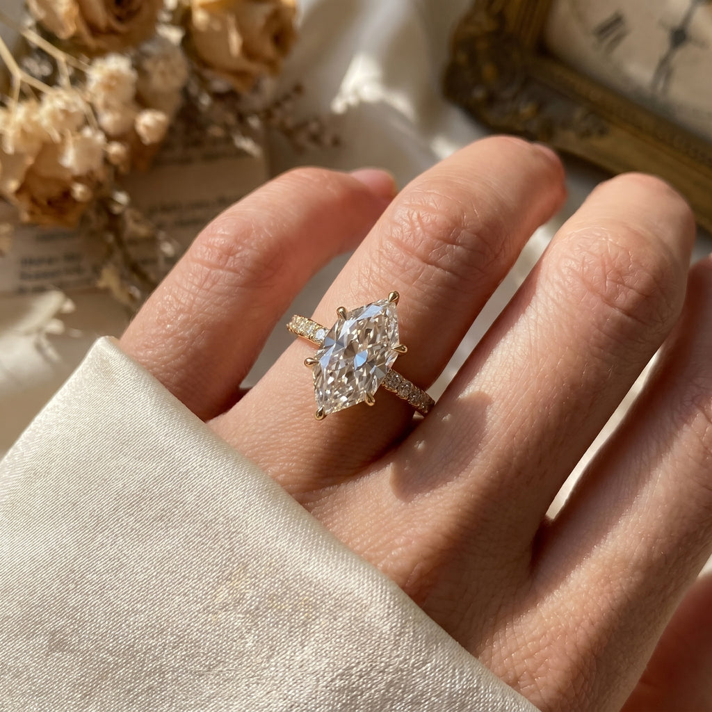 Marquise diamond engagement ring worn on hand showcasing elegant size, sparkle and pavé diamond band