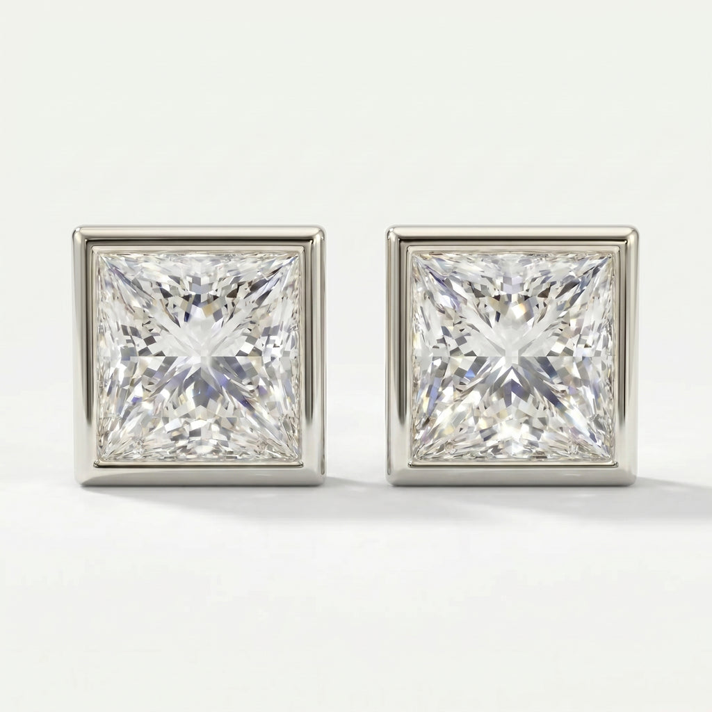 Pair of square-cut diamond earrings on a light gray background