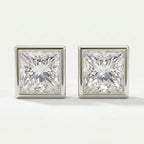 Pair of square-cut diamond earrings on a light gray background