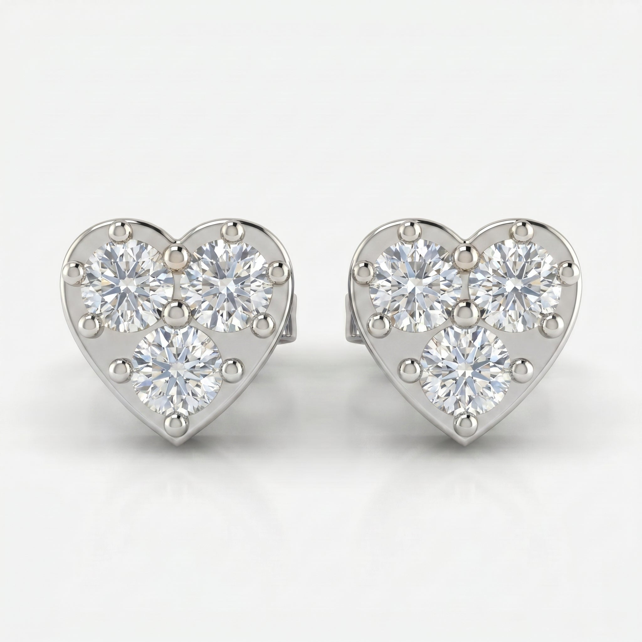 Top view of White gold heart stud earrings featuring round brilliant diamond cluster design