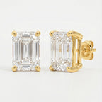 Gold emerald-cut diamond earrings on a light gray background