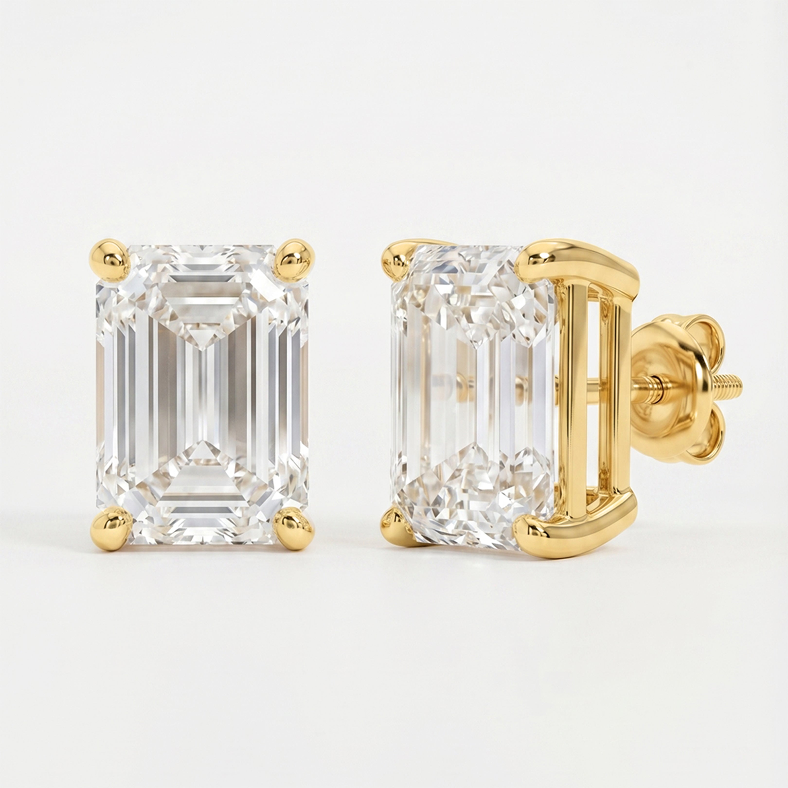 Gold emerald-cut diamond earrings on a light gray background