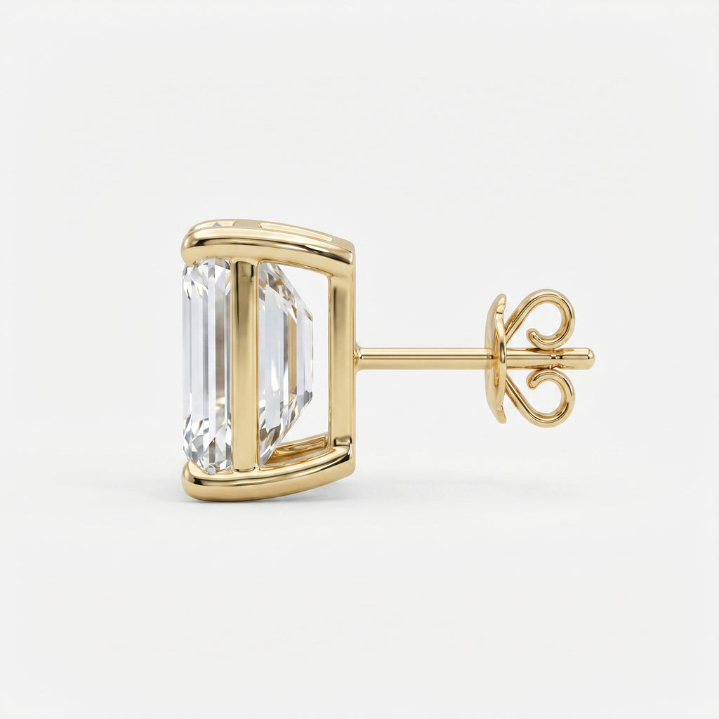 Gold earring with a large clear gemstone on a white background
