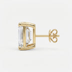 Gold earring with a large clear gemstone on a white background