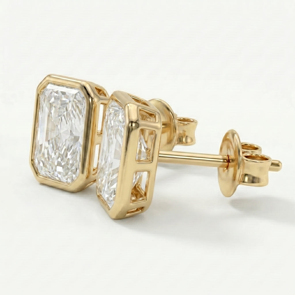 Gold earrings with diamond-like stones on a white background
