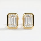 Gold emerald-cut earrings on a white background