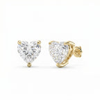 Heart-shaped diamond earrings with gold prongs on a white background