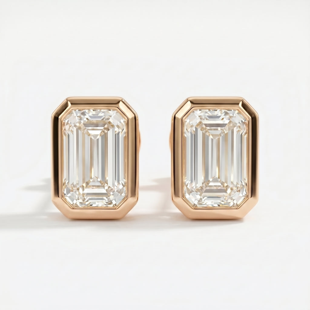 Pair of diamond earrings with rose gold setting on a white background