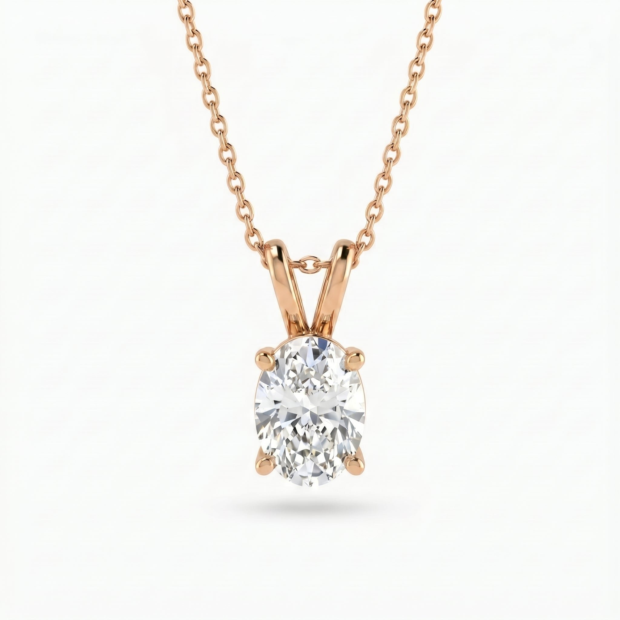 Rose gold necklace with a diamond pendant on a white background