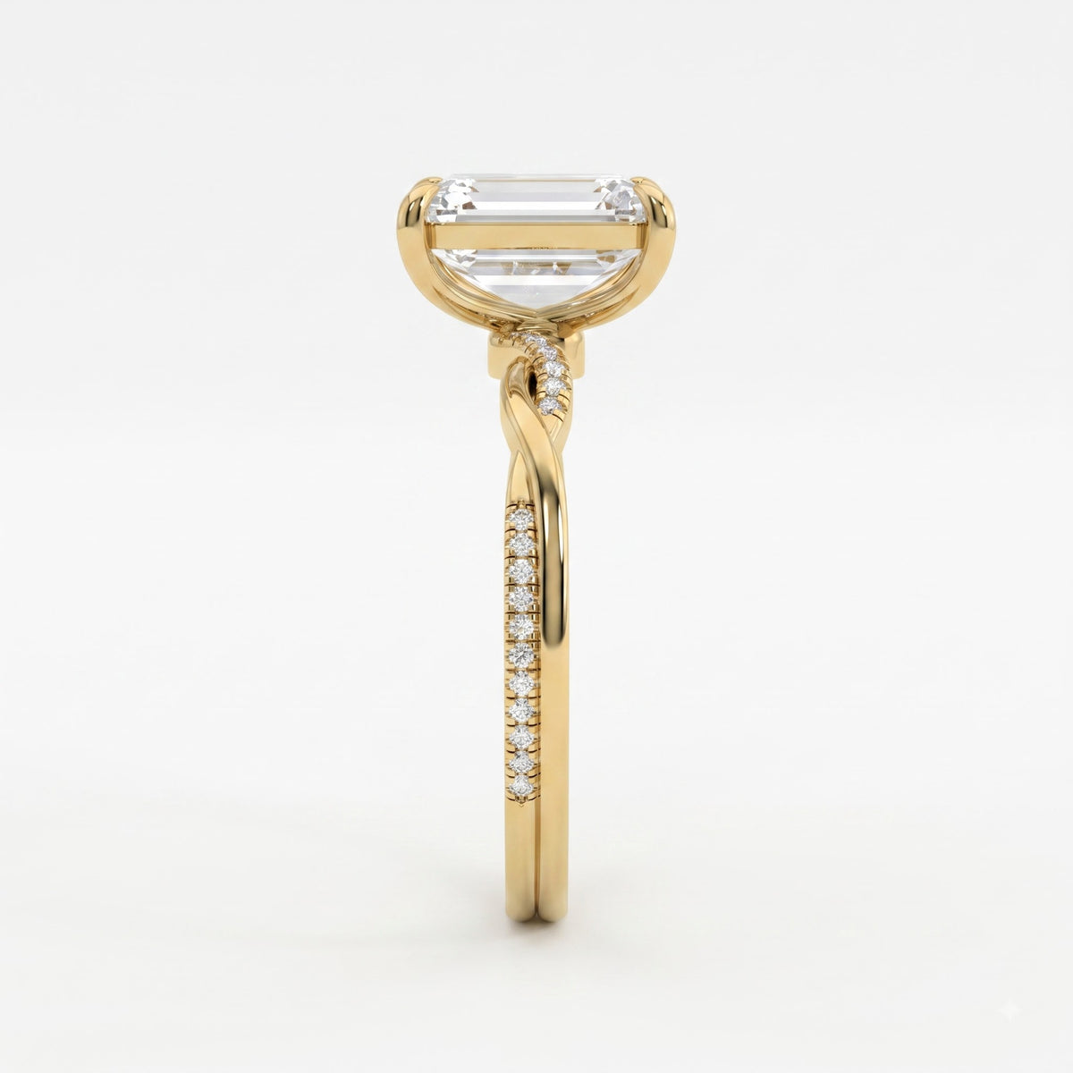 The Lumière Emerald Cut Diamond Twisted Pavé Side Stone Ring