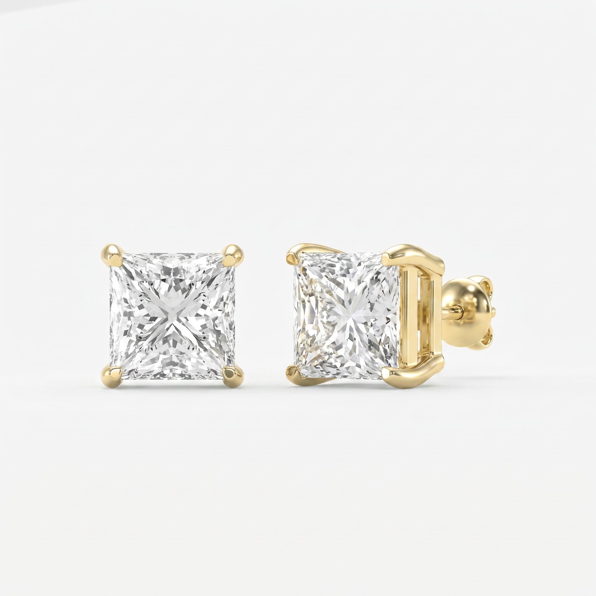 Gold earrings with square-cut diamonds on a white background