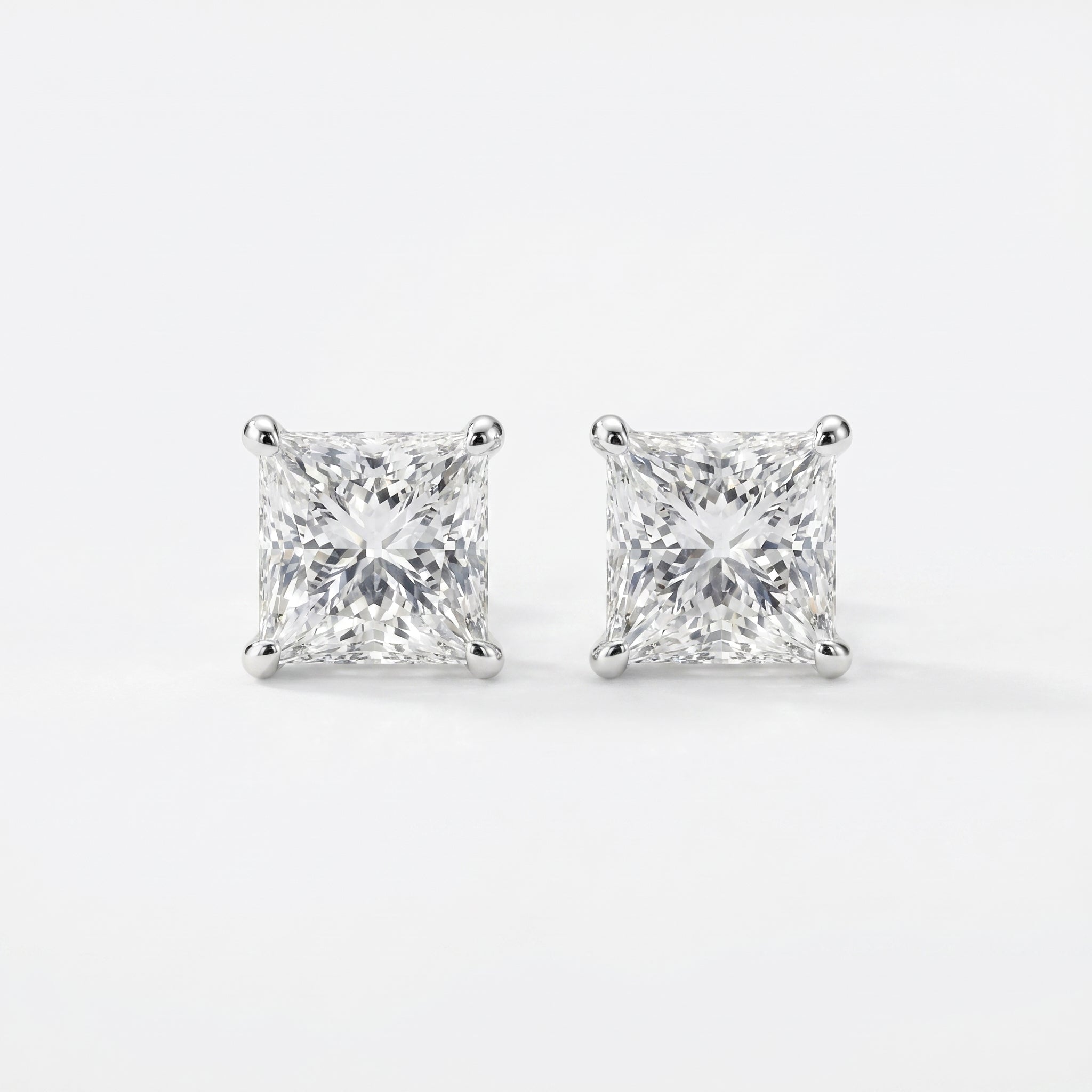 Pair of diamond stud earrings on a white background