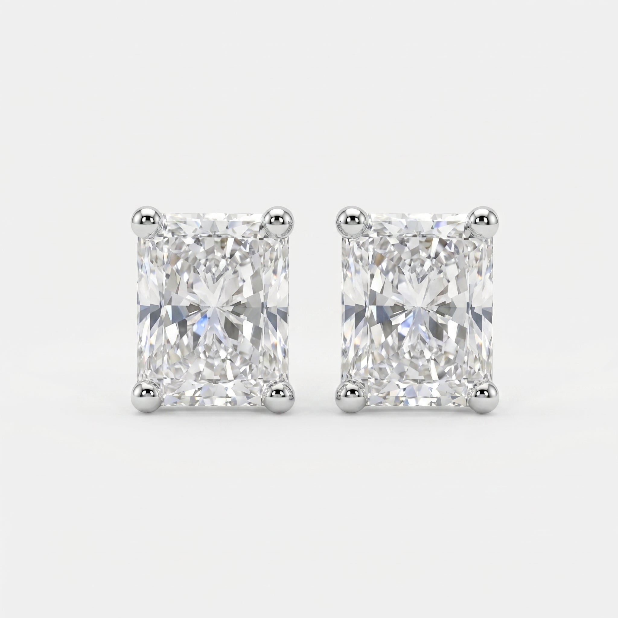 Pair of diamond stud earrings on a light gray background