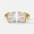 Gold earrings with rectangular cut diamonds on a white background