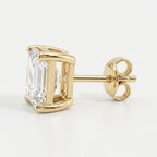 Gold earring with a clear gemstone on a white background