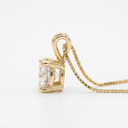 Gold pendant with a large diamond on a white background