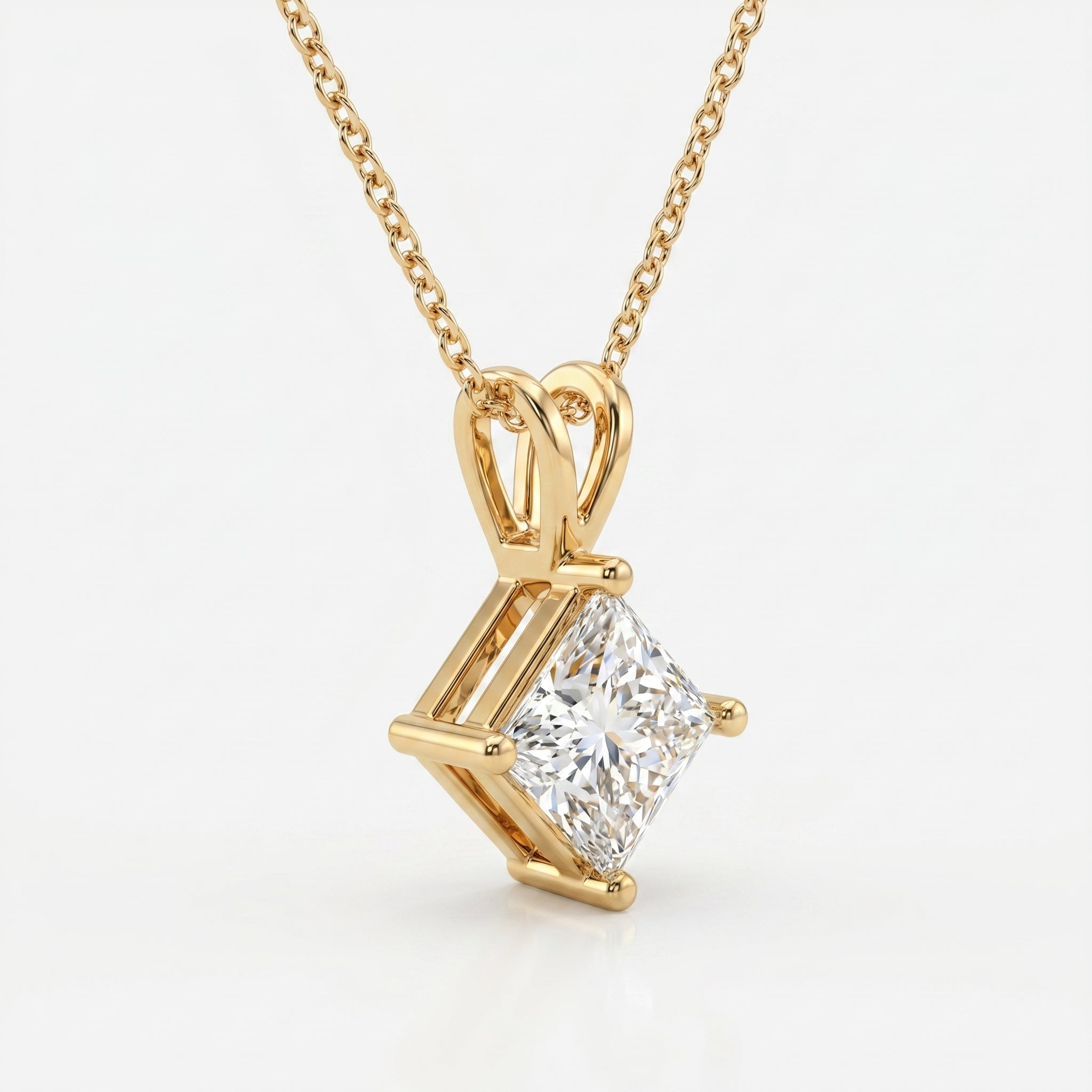 Gold necklace with a diamond pendant on a white background