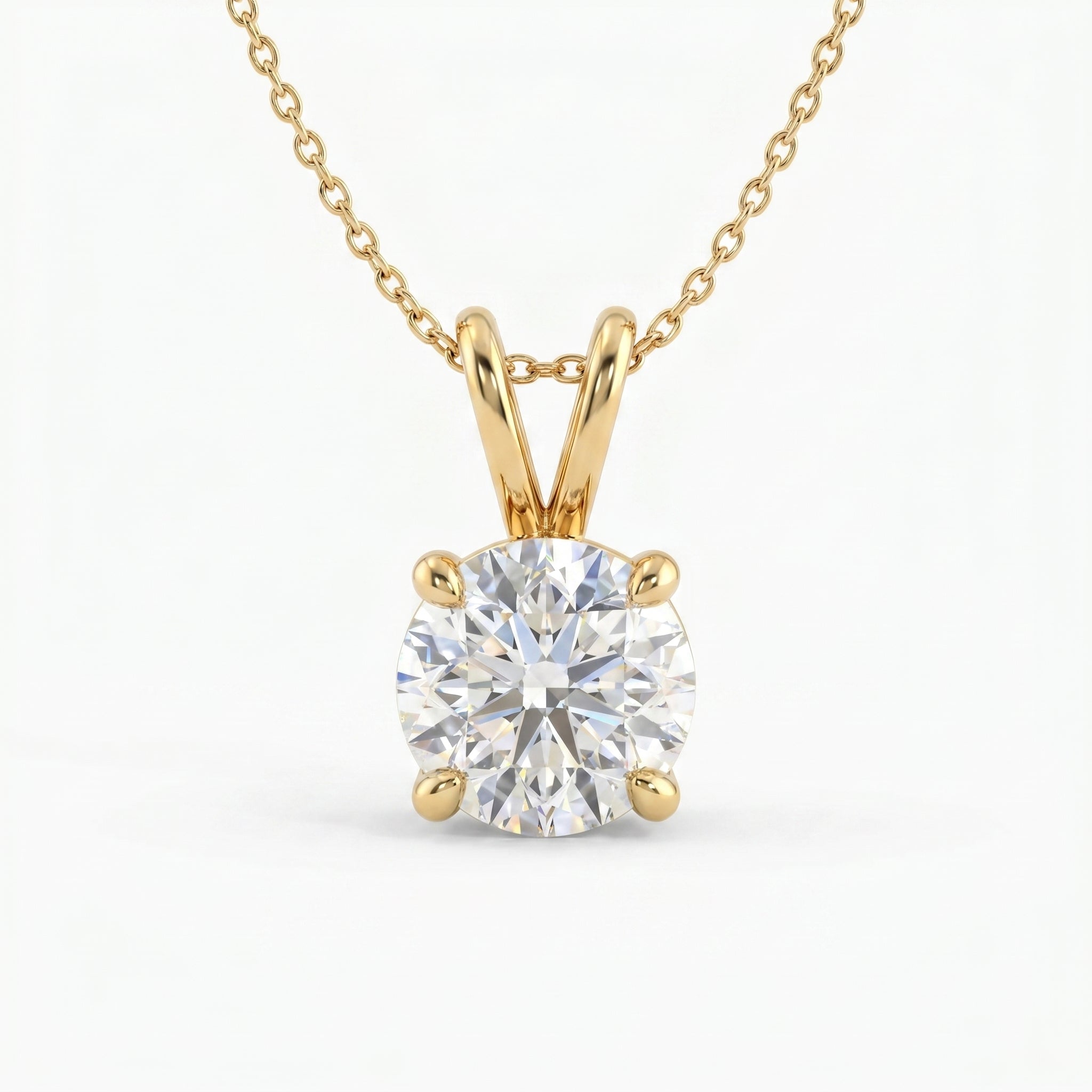 Gold necklace with a round diamond pendant on a white background