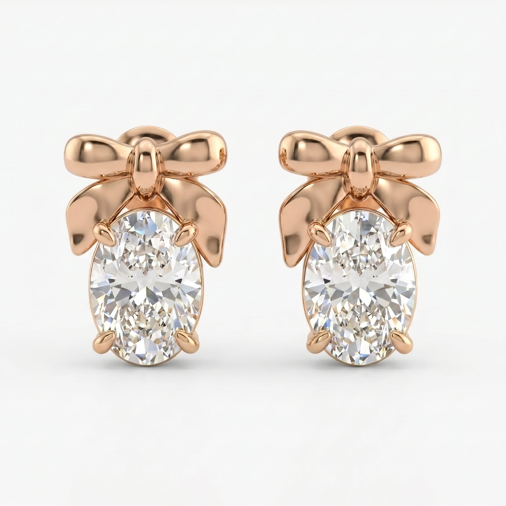 Rose gold bow stud earrings with oval-cut diamond stones on white background, elegant minimalist luxury jewelry